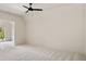 Bright and airy bedroom featuring neutral walls, plush carpeting and modern ceiling fan at 6055 Tattnall Overlook, Acworth, GA 30101