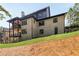 This exterior view reveals a home with a light brick exterior, dark trim, and multiple windows, creating a stylish and modern aesthetic at 6055 Tattnall Overlook, Acworth, GA 30101