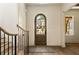 Light filled foyer featuring a gorgeous arched wooden door and stairs at 6055 Tattnall Overlook, Acworth, GA 30101