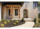 Inviting stone front porch with natural wood supports and arched door at 6055 Tattnall Overlook, Acworth, GA 30101