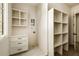 Bright laundry room with custom cabinet and drawers, a window and storage shelves for organized living at 6055 Tattnall Overlook, Acworth, GA 30101
