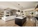 Open concept living space with kitchen island, stainless appliances, and comfortable living area with fireplace at 6055 Tattnall Overlook, Acworth, GA 30101