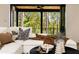 Relaxing living room with a plush sofa, stylish pillows, and a view of the serene wooded outdoors at 6055 Tattnall Overlook, Acworth, GA 30101
