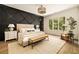 Spacious bedroom with natural light and contemporary design, including a dark accent wall at 6055 Tattnall Overlook, Acworth, GA 30101