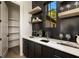 Walk-in pantry with shelving beside the home bar featuring dark cabinets, white countertop, and stylish window at 6055 Tattnall Overlook, Acworth, GA 30101