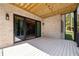 Exterior covered porch with brick walls, sliding glass doors, wooden ceilings, and a white floor at 6055 Tattnall Overlook, Acworth, GA 30101