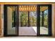 Covered porch featuring sliding glass doors that lead to a deck surrounded by trees at 6055 Tattnall Overlook, Acworth, GA 30101