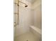 Walk-in shower with sleek design, features vertically laid tiles, bronze shower head and fixtures and built in bench at 6055 Tattnall Overlook, Acworth, GA 30101