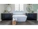 Contemporary bathroom with dual vanities, freestanding tub, and luxurious finishes at 64 Telfair Ct, Acworth, GA 30101