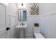 Charming half-bathroom with crisp white wainscoting, a pedestal sink, and modern accents at 64 Telfair Ct, Acworth, GA 30101