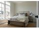 Bright bedroom featuring a wooden headboard, stylish lamps, and ample natural light at 64 Telfair Ct, Acworth, GA 30101