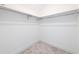 Walk-in closet with carpeted floor and installed clothing racks at 64 Telfair Ct, Acworth, GA 30101