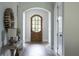 Elegant foyer featuring arched doorway and wood floors at 64 Telfair Ct, Acworth, GA 30101