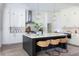 Spacious kitchen features stainless steel appliances, white cabinets, and a large island with seating at 64 Telfair Ct, Acworth, GA 30101