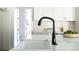 Modern black faucet over a white kitchen sink and countertop at 64 Telfair Ct, Acworth, GA 30101