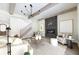 Bright living room with beamed ceilings, fireplace, staircase and stylish decor at 64 Telfair Ct, Acworth, GA 30101