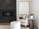 Stylish chair in living room featuring a modern fireplace and neutral color palette at 64 Telfair Ct, Acworth, GA 30101