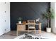 Cozy office featuring a black accent wall, natural wood desk, and statement zebra rug at 64 Telfair Ct, Acworth, GA 30101