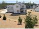 Backyard view of a two-story home in a neighborhood with mature trees at 64 Telfair Ct, Acworth, GA 30101