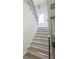 Staircase featuring hardwood steps, black iron railing, and natural light at 64 Telfair Ct, Acworth, GA 30101