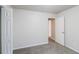 This bedroom offers neutral walls, plush carpet, and multiple doors leading to other rooms at 844 Glenshire Ct, Riverdale, GA 30274