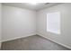 Well-lit bedroom with plush carpeting and a large window offering a comfortable atmosphere at 844 Glenshire Ct, Riverdale, GA 30274