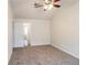 Large bedroom with neutral carpet and a ceiling fan featuring convenient access to other rooms at 844 Glenshire Ct, Riverdale, GA 30274