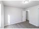 Bright bedroom featuring laminate wood flooring, a ceiling light and entry to a hallway at 844 Glenshire Ct, Riverdale, GA 30274
