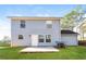 The backyard features green grass, a concrete patio and a two-story home with a blue exterior at 844 Glenshire Ct, Riverdale, GA 30274