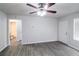 Living room showcases wood-look floors, a ceiling fan, and a door leading to the outside at 844 Glenshire Ct, Riverdale, GA 30274