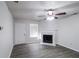 Bright living room featuring a fireplace, ceiling fan, neutral walls, and wood-look flooring at 844 Glenshire Ct, Riverdale, GA 30274