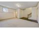 Finished basement featuring carpet, a staircase, and a small window at 961 Persimmon Pt, Atlanta, GA 30328