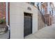 Basement entrance with a gated door with '961' on wall, part of brick front home at 961 Persimmon Pt, Atlanta, GA 30328