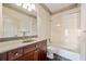 Bathroom features single vanity with granite countertop and a tub/shower combo at 961 Persimmon Pt, Atlanta, GA 30328