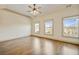 Spacious bedroom features hardwood floors, three large windows, and modern ceiling fan at 961 Persimmon Pt, Atlanta, GA 30328