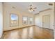 Bedroom featuring hardwood floors, three large windows, and a ceiling fan at 961 Persimmon Pt, Atlanta, GA 30328