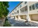 Exterior view of townhomes featuring private garages and screened in porches at 961 Persimmon Pt, Atlanta, GA 30328