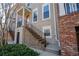 This townhome has a private entrance with brick stairs leading to the main level and a red front door at 961 Persimmon Pt, Atlanta, GA 30328