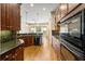 Kitchen featuring modern stainless steel appliances, dark wood cabinets, and granite countertops at 961 Persimmon Pt, Atlanta, GA 30328