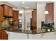 Kitchen featuring granite countertops, stainless steel appliances, and a breakfast bar overlooking the living room at 961 Persimmon Pt, Atlanta, GA 30328