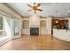 Bright living room featuring a fireplace, custom built-ins, wood floors, and access to the outdoor porch at 961 Persimmon Pt, Atlanta, GA 30328