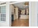 View of living room featuring a fireplace and custom built-ins and adjacent kitchen through open doorway at 961 Persimmon Pt, Atlanta, GA 30328