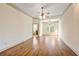 Spacious main bedroom with hardwood floors, ceiling fan, and ensuite bathroom at 961 Persimmon Pt, Atlanta, GA 30328