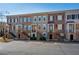 Row of varied brick and siding townhomes with stoops and small front yards, offering city living at 961 Persimmon Pt, Atlanta, GA 30328