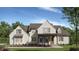 Charming two-story home with brick exterior, covered porch, and well-manicured lawn at 105 Dallas Mark Drive, Canton, GA 30115
