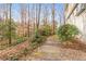 A tranquil backyard walkway showcasing the home's natural surroundings and private setting at 345 W Spalding Dr, Sandy Springs, GA 30328