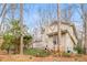 Expansive backyard featuring a wooden deck, lush foliage, and fencing, offers privacy and outdoor living at 345 W Spalding Dr, Sandy Springs, GA 30328