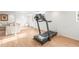 A versatile basement area with a treadmill and cozy seating, perfect for fitness and relaxation at 345 W Spalding Dr, Sandy Springs, GA 30328