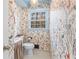 Stylish powder room with whimsical butterfly wallpaper and a window providing natural light at 345 W Spalding Dr, Sandy Springs, GA 30328