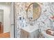 Charming powder room featuring floral wallpaper, a sink with curtain, and elegant lighting at 345 W Spalding Dr, Sandy Springs, GA 30328